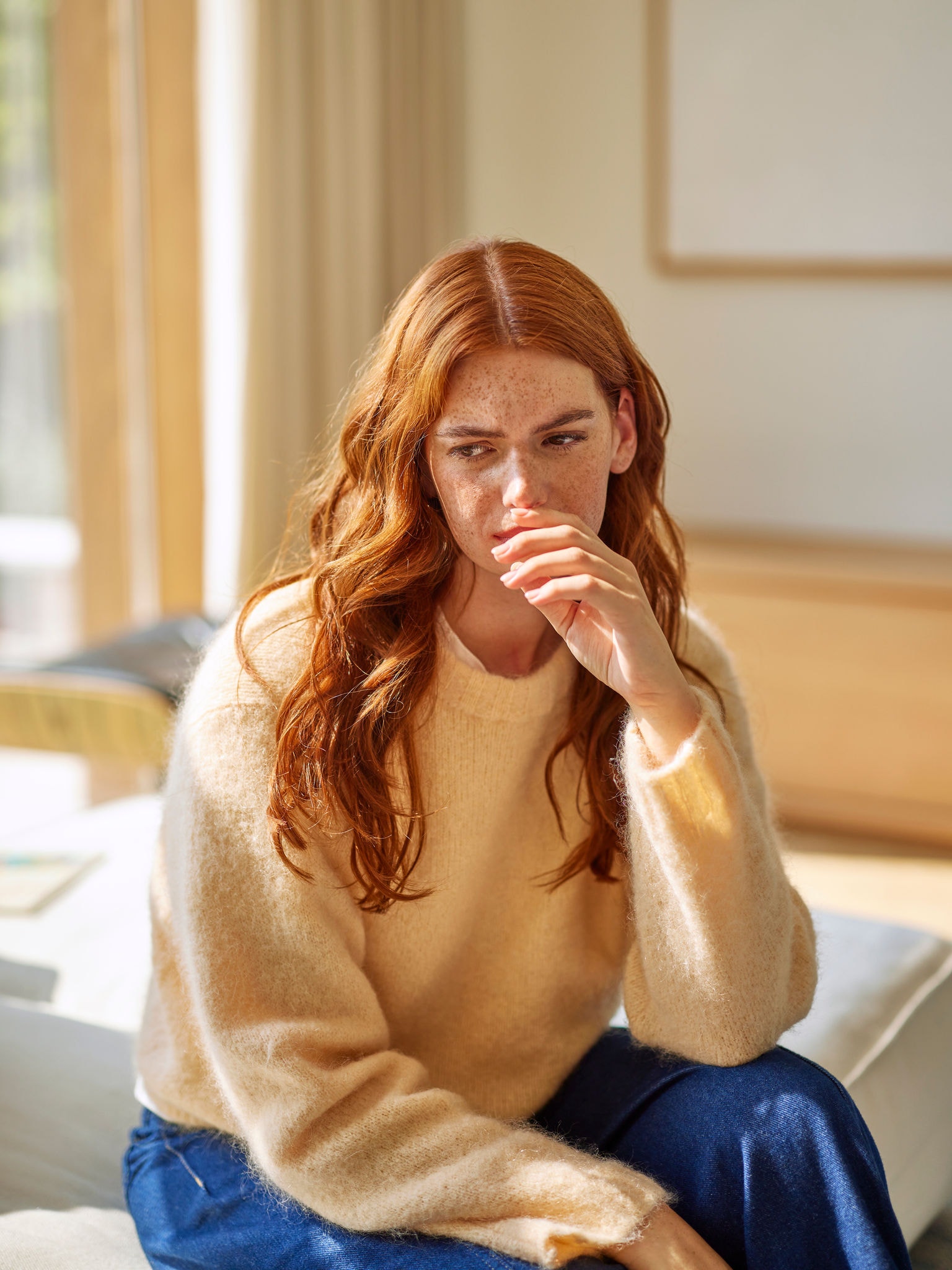 Kvinna som reagerar på obehagliga matos i vardagsrummet