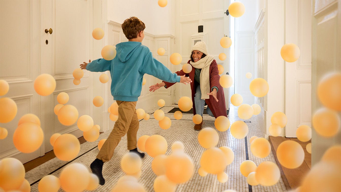 Mamma leker med sin dotter i skönt inomhusklimat med en Daikin luftvärmepump